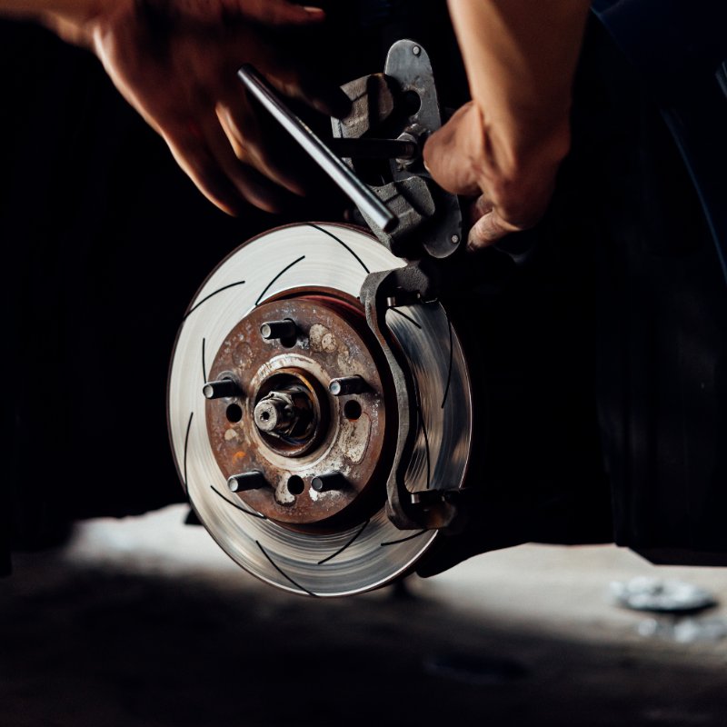 close-up of a mechanic working on car brakes