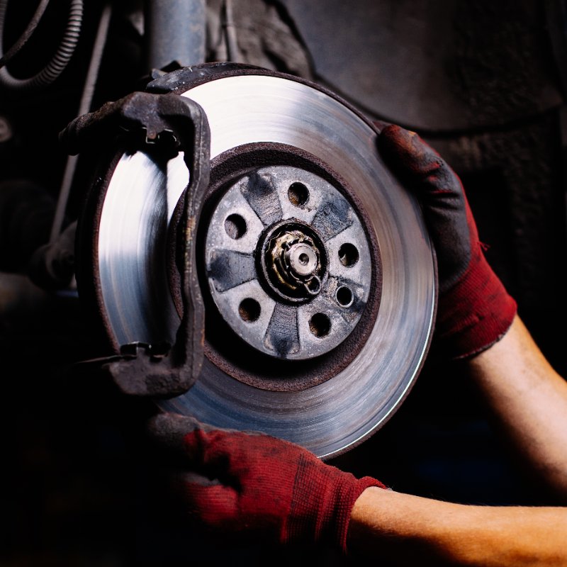 close-up of a mechanic installing car brakes