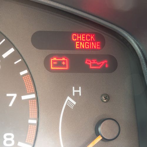 A Picture of a Check Engine Light On a Car Dashboard.